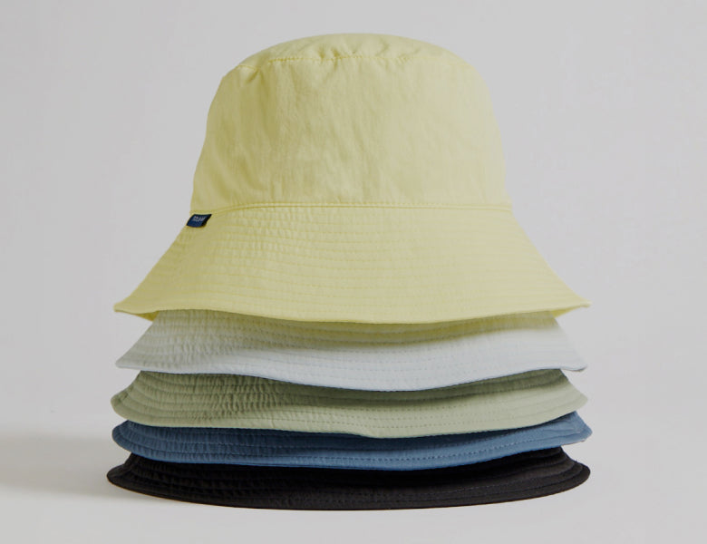 Stack of colorful bucket hats on a white background
