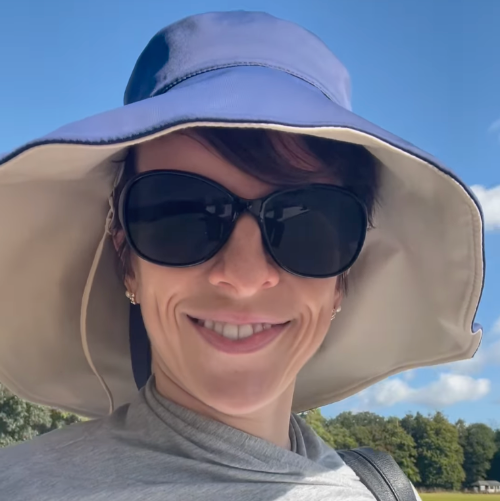 Woman wearing a blue and beige Solbari sun hat